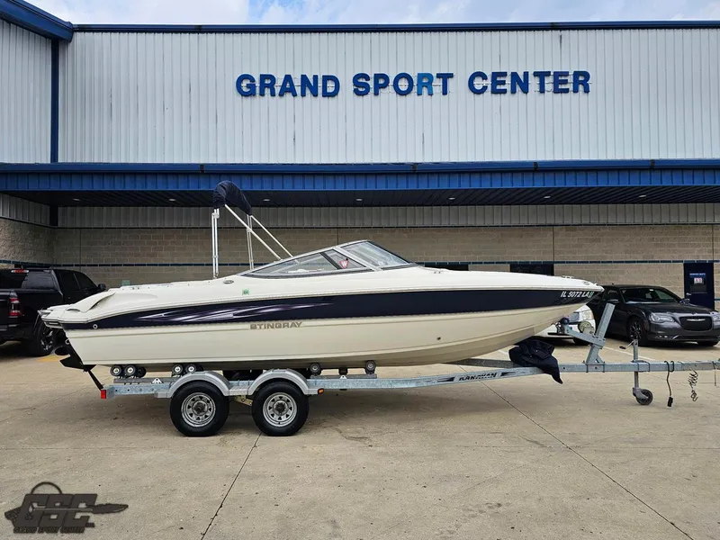 Slide: The Image of 2013 Stingray 225 LR boat on trailer at Grand Sport Center. - 1