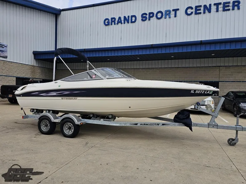 Slide: The Image of 2013 Stingray 225 LR boat on trailer at Grand Sport Center. - 10