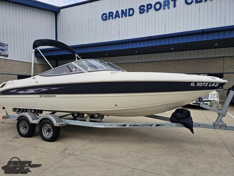 Slide: The Image of 2013 Stingray 225 LR boat on trailer outside Grand Sport Center. - 11