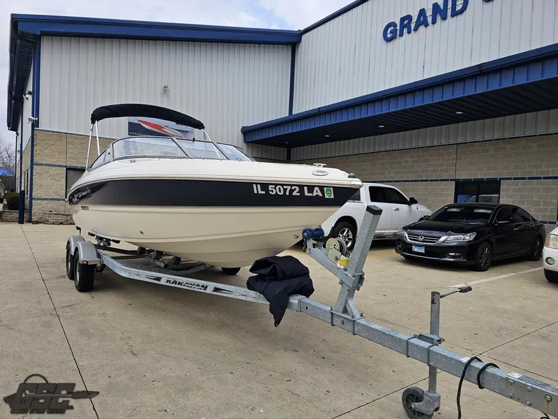Slide: The Image of 2013 Stingray 225 LR boat on trailer outside dealership. - 12