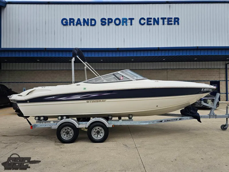 Slide: The Image of 2013 Stingray 225 LR boat on trailer at Grand Sport Center. - 2