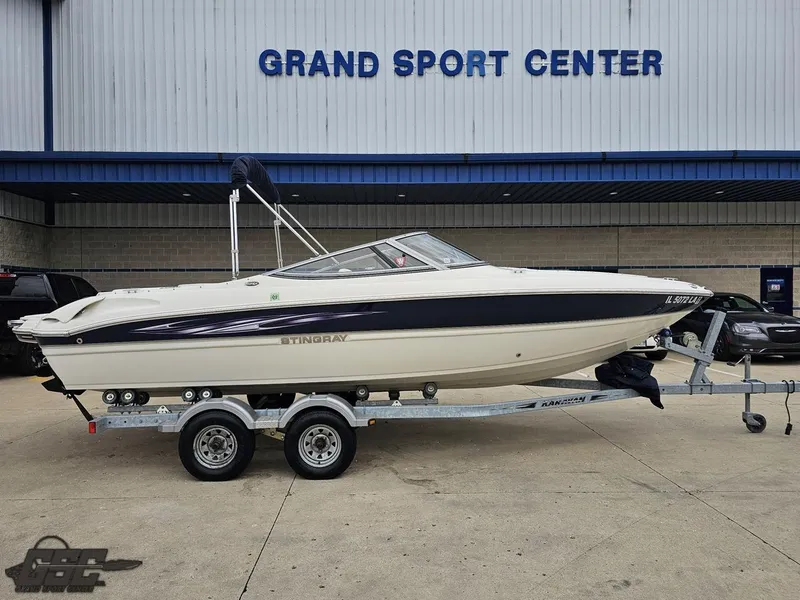 Slide: The Image of 2013 Stingray 225 LR boat on trailer at Grand Sport Center. - 3