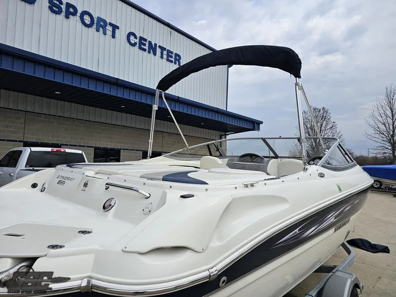 Slide: The Image of 2013 Stingray 225 LR boat at a sport center, featuring sleek design and white exterior. - 32