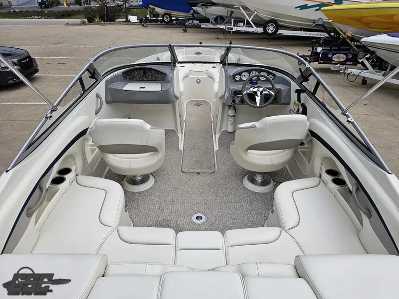 Slide: The Image of 2013 Stingray 225 LR boat interior with white seating and steering console. - 39