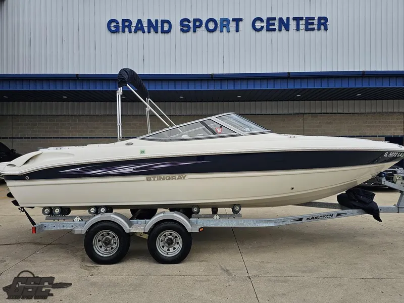 Slide: The Image of 2013 Stingray 225 LR boat on trailer at Grand Sport Center. - 4