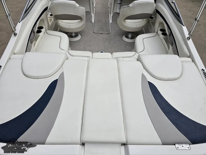 Slide: The Image of 2013 Stingray 225 LR boat interior with white and gray seating, cup holders, and carpeted flooring. - 41