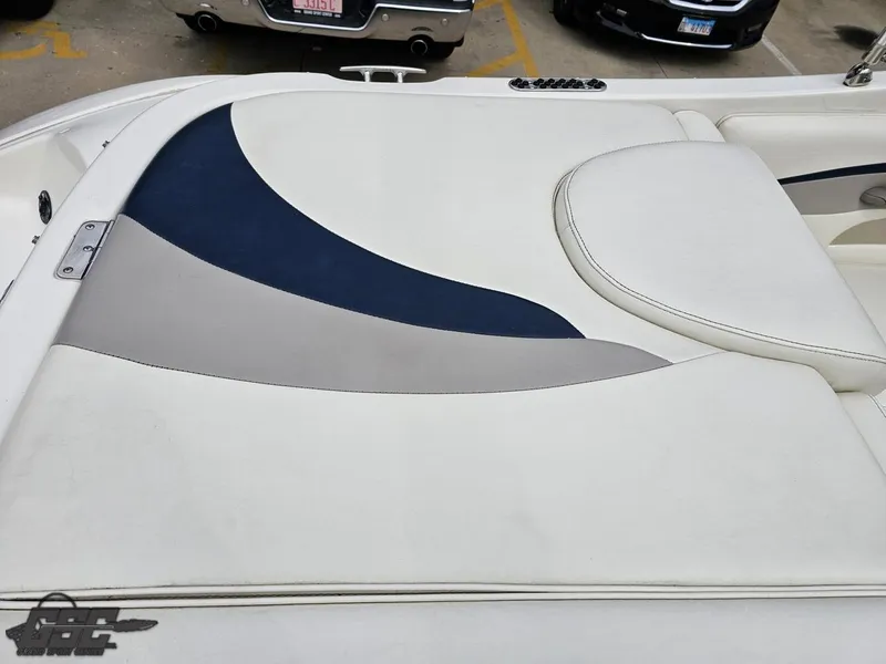 Slide: The Image of 2013 Stingray 225 LR boat interior with white, blue, and gray upholstery design. - 42