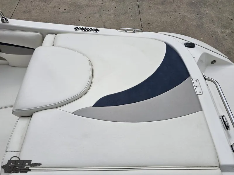 Slide: The Image of 2013 Stingray 225 LR boat interior with white and blue cushioned seating. - 43