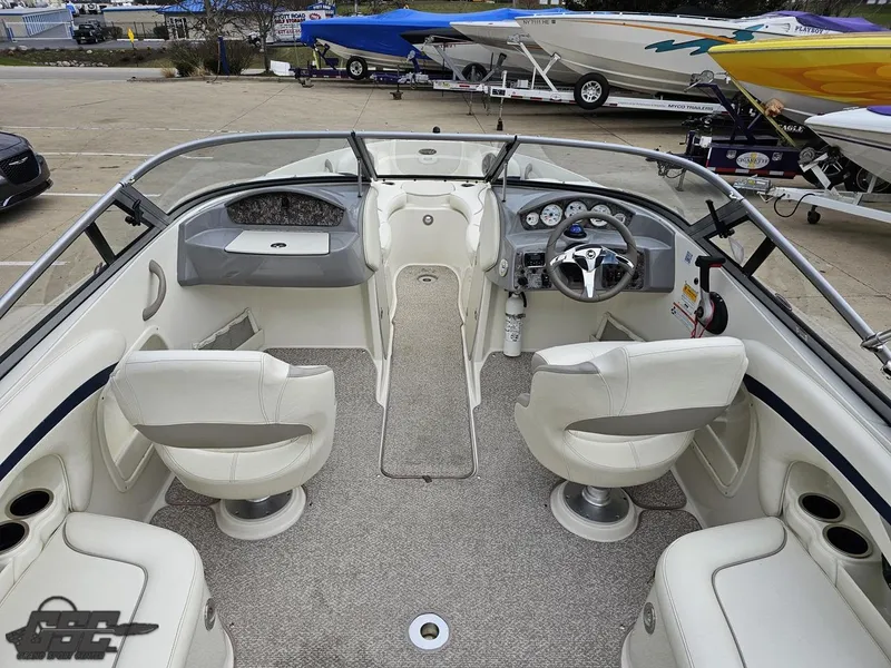 Slide: The Image of 2013 Stingray 225 LR boat interior with white seating and modern dashboard. - 46