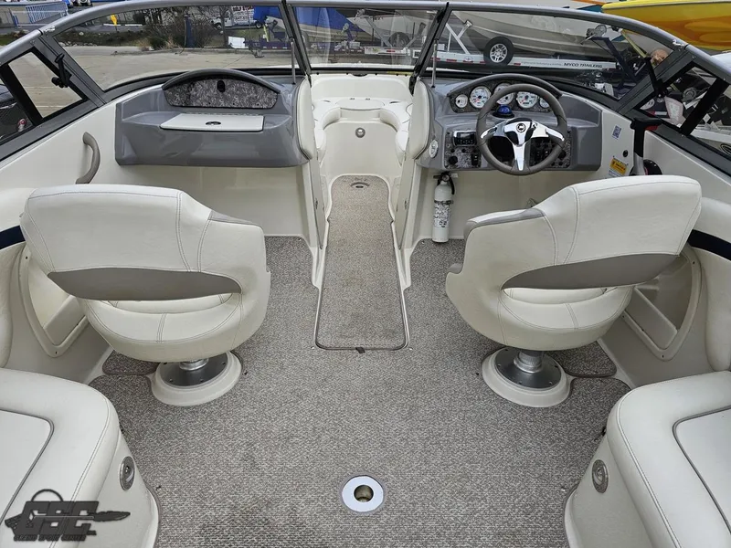 Slide: The Image of 2013 Stingray 225 LR boat interior with plush seating and modern dashboard. - 47