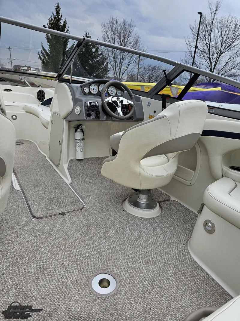 Slide: The Image of 2013 Stingray 225 LR boat interior with steering wheel and seating, featuring modern design. - 49