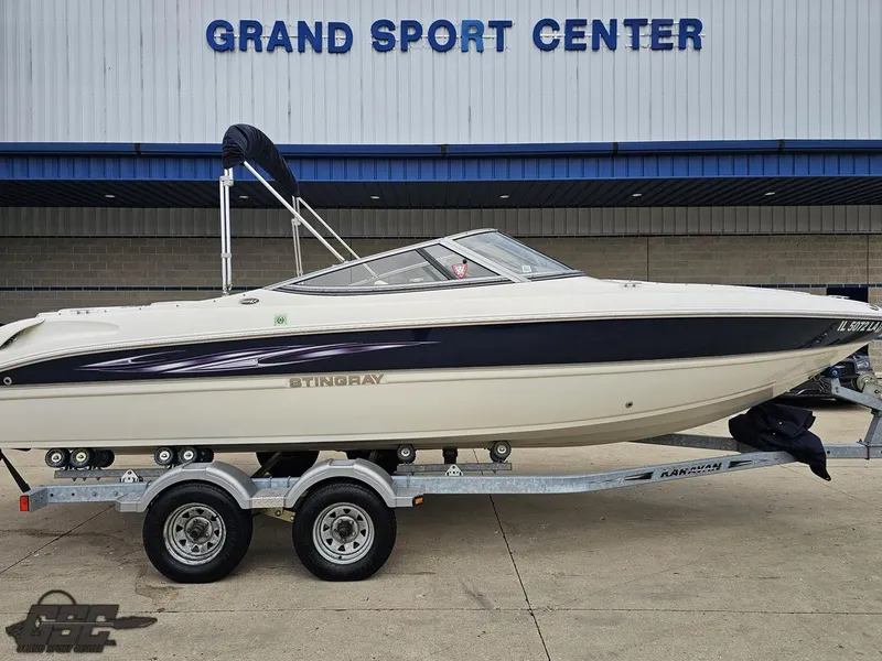 Slide: The Image of 2013 Stingray 225 LR boat on trailer at Grand Sport Center. - 5