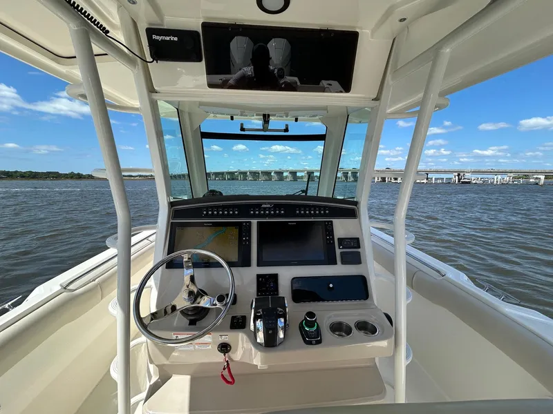 Slide: The Image of 2021 Boston Whaler 330 Outrage helm with modern controls on open water. - 21