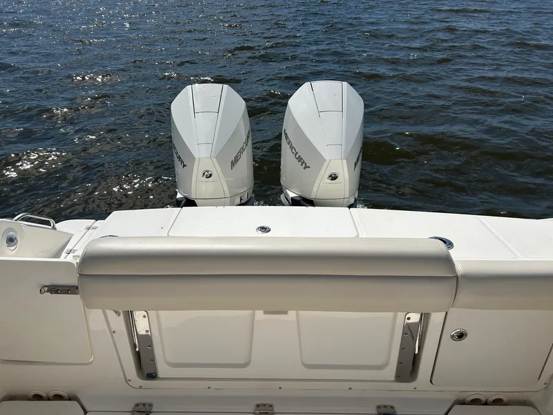 Slide: The Image of 2021 Boston Whaler 330 Outrage with twin Mercury outboard engines on the water. - 27