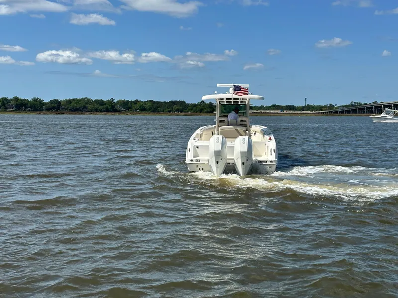 Slide: The Image of Boston Whaler 330 Outrage 2021 cruising on a sunny day with clear skies. - 5