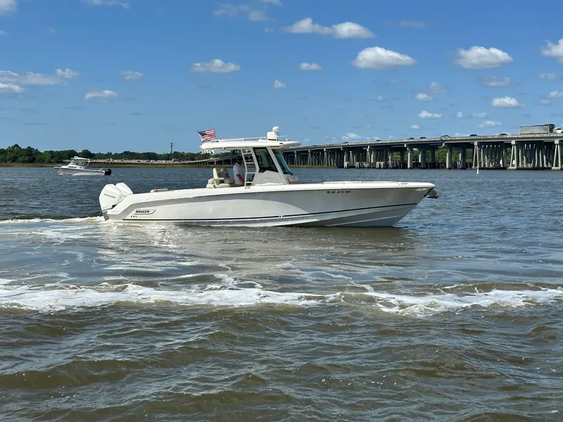 Slide: The Image of Boston Whaler 330 Outrage 2021 cruising on a sunny day near a bridge. - 9