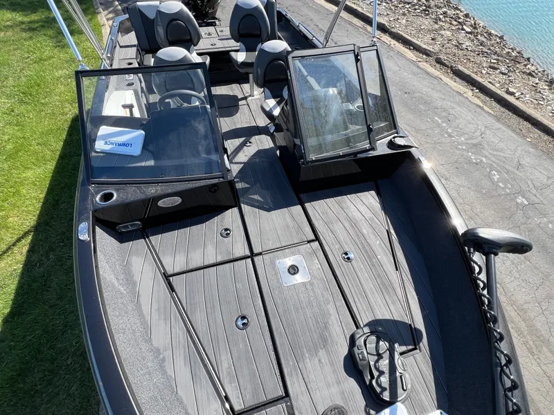 Slide: The Image of 2025 Vexus ADX190 boat with dual consoles, spacious seating, and sleek design by the water. - 22