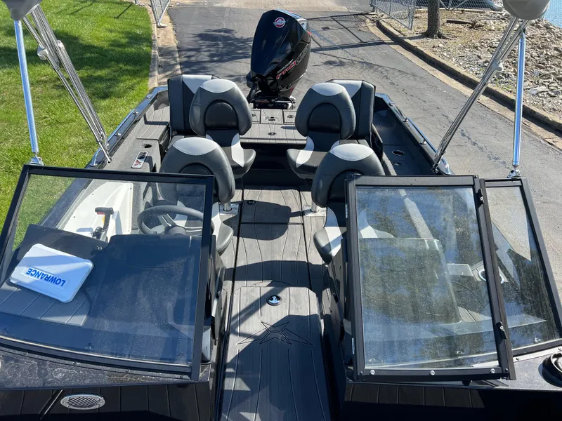 Slide: The Image of 2025 Vexus ADX190 boat with open cockpit, seating, and outboard motor. - 23