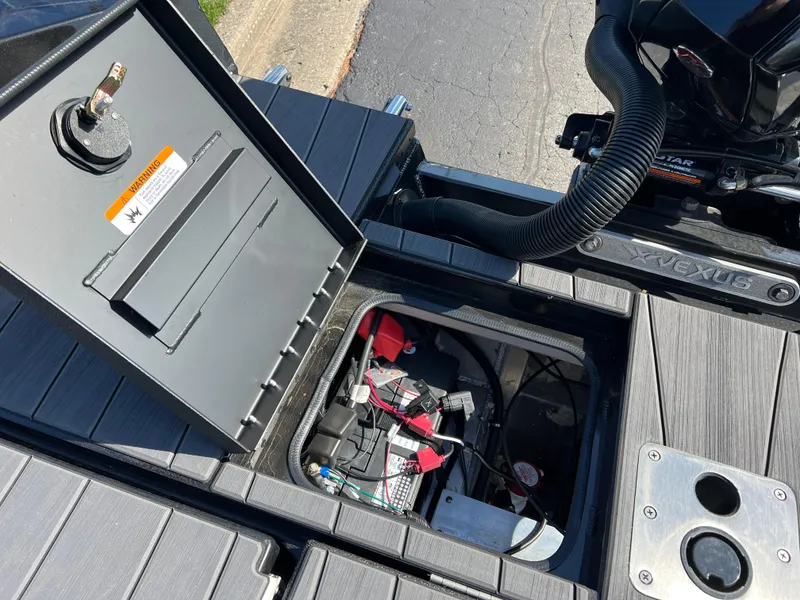 Slide: The Image of Open storage compartment of 2025 Vexus ADX190 boat showing battery and wiring. - 32
