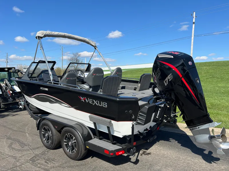 Slide: The Image of 2025 Vexus ADX190 boat on trailer, sleek design, powerful outboard motor, sunny day. - 8
