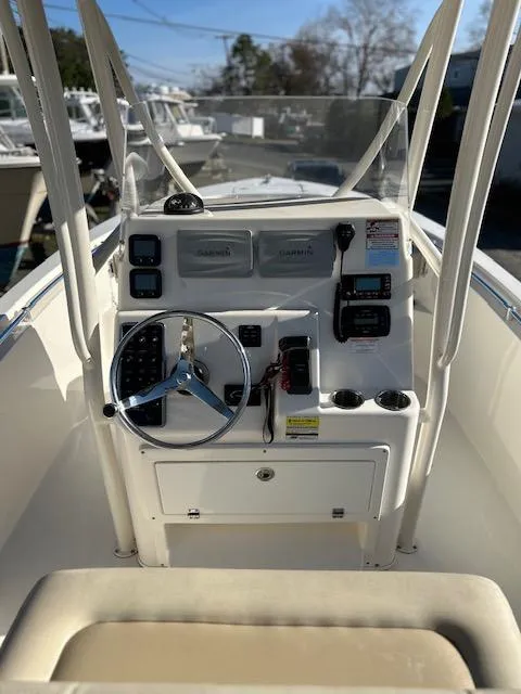 Slide: The Image of 2015 Cobia 237 Center Console boat dashboard with steering wheel and navigation controls. - 1