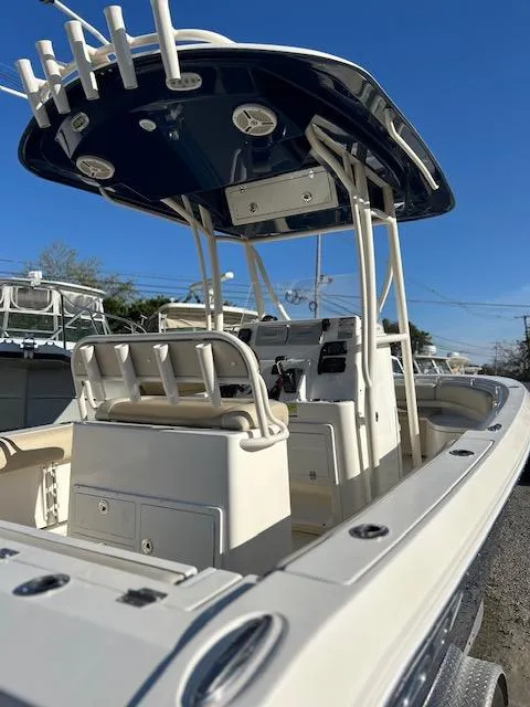 Slide: The Image of 2015 Cobia 237 Center Console boat with T-top and rod holders, viewed from the stern. - 4