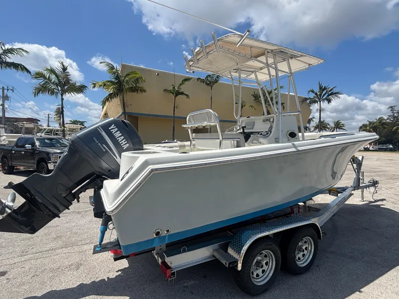 Slide: The Image of 2007 Sailfish 218 CC boat on trailer with Yamaha outboard motor, parked outdoors. - 1