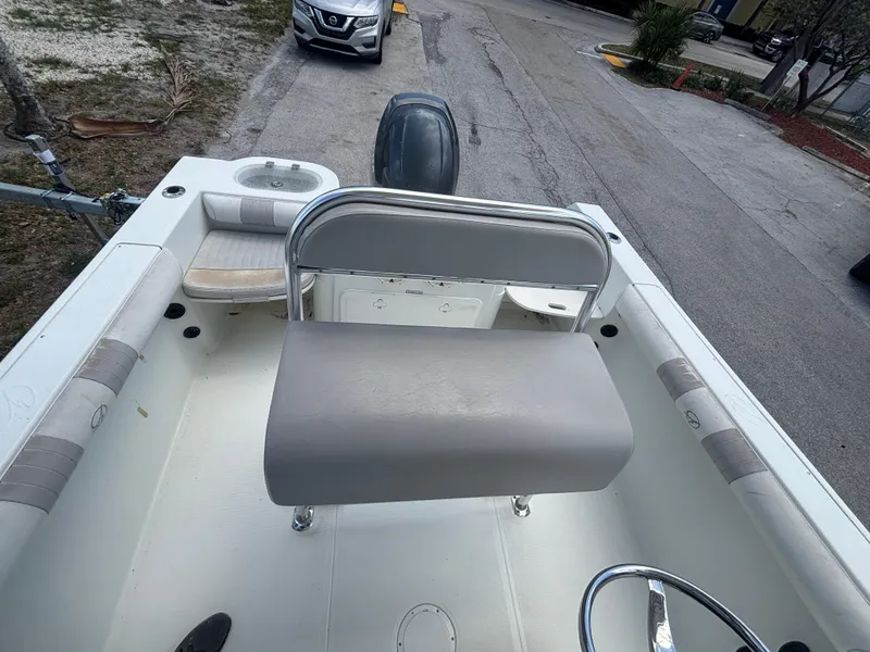 Slide: The Image of 2007 Sailfish 218 CC boat interior with seating and steering wheel, parked on a street. - 12