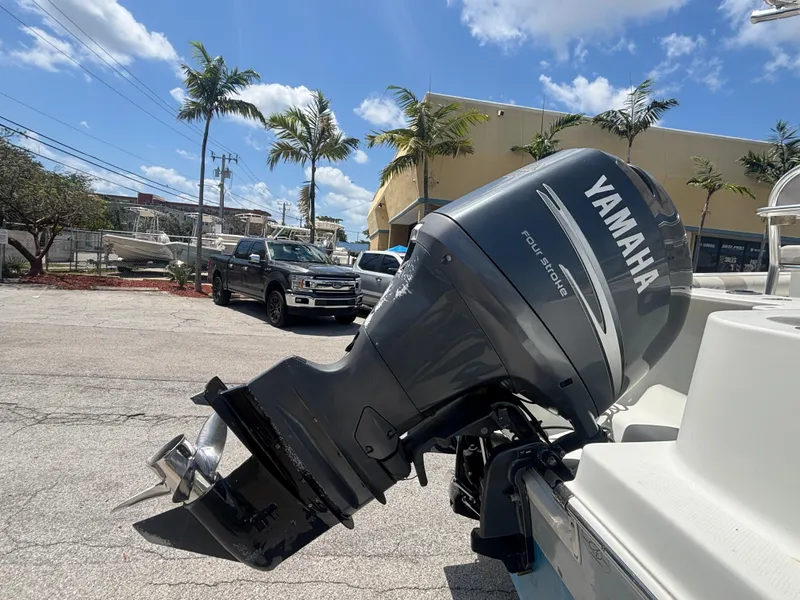 Slide: The Image of Yamaha outboard motor on 2007 Sailfish 218 CC boat, parked under clear blue sky. - 15