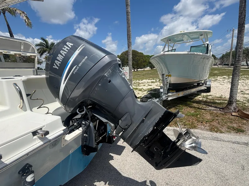 Slide: The Image of 2007 Sailfish 218 CC boat with Yamaha outboard motor, parked on a sunny day. - 16