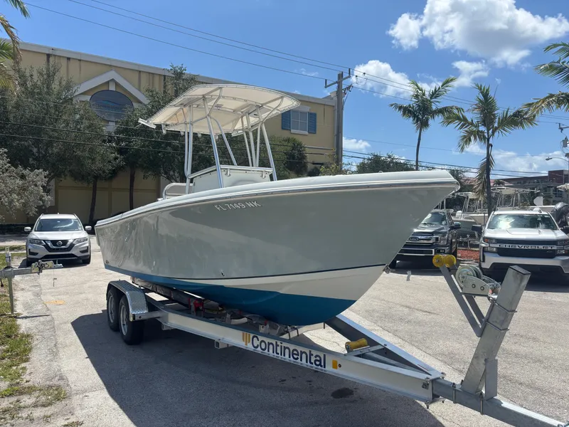 Slide: The Image of 2007 Sailfish 218 CC boat on trailer, parked outdoors under a clear sky. - 5