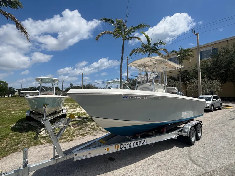 Slide: The Image of 2007 Sailfish 218 CC boat on trailer, parked outdoors under a sunny sky. - 6