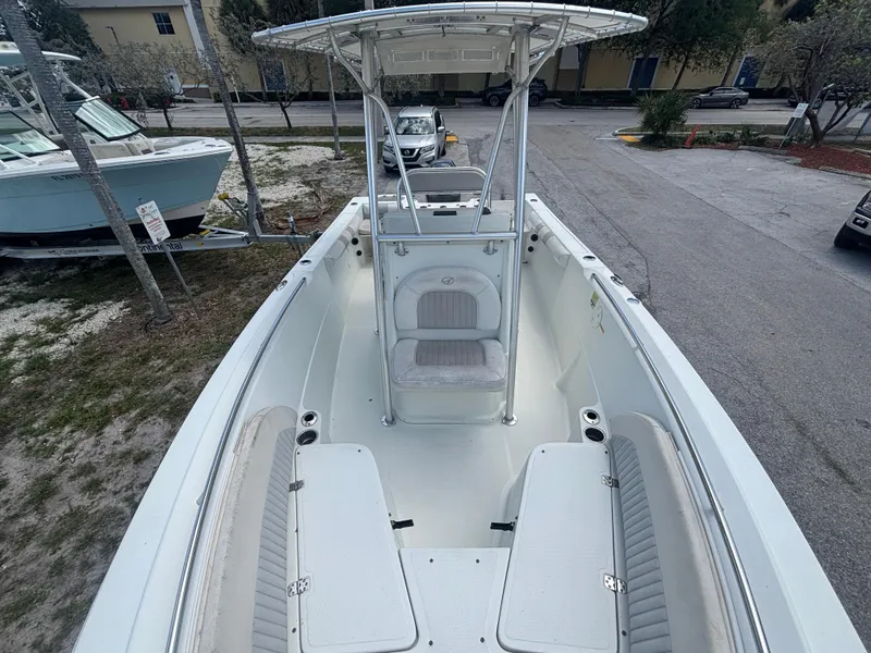 Slide: The Image of 2007 Sailfish 218 CC boat with spacious seating and T-top in a parking area. - 7