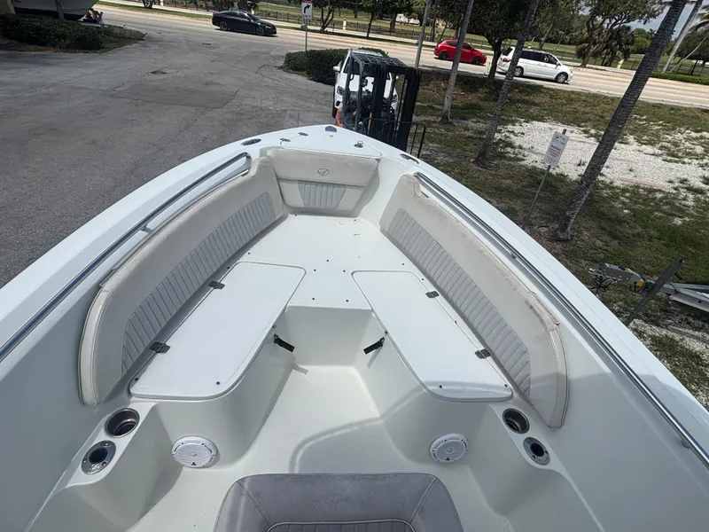 Slide: The Image of 2007 Sailfish 218 CC boat with spacious seating and cup holders, parked outdoors. - 9