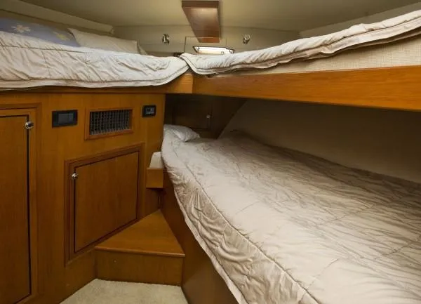 Slide: The Image of 1982 Pacifica Convertible interior with wooden bunk beds and cozy bedding. - 12