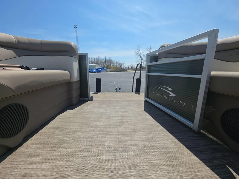 Slide: The Image of 2020 Bennington S 20 SS pontoon boat interior with open gate, sunny day. - 10