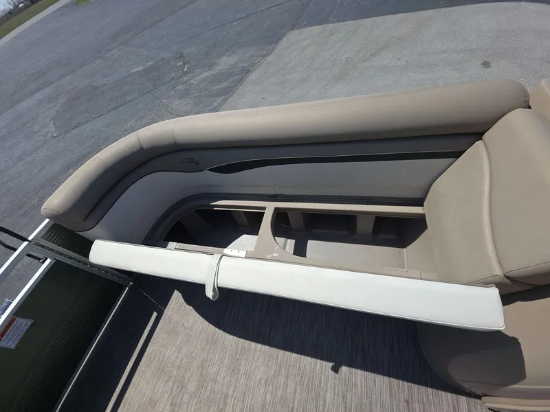 Slide: The Image of 2020 Bennington S 20 SS boat interior with beige seating and storage compartments. - 12