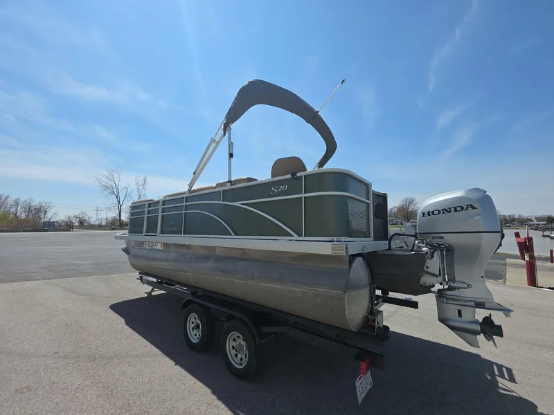 Slide: The Image of 2020 Bennington S 20 SS pontoon boat with Honda outboard motor on a trailer. - 3