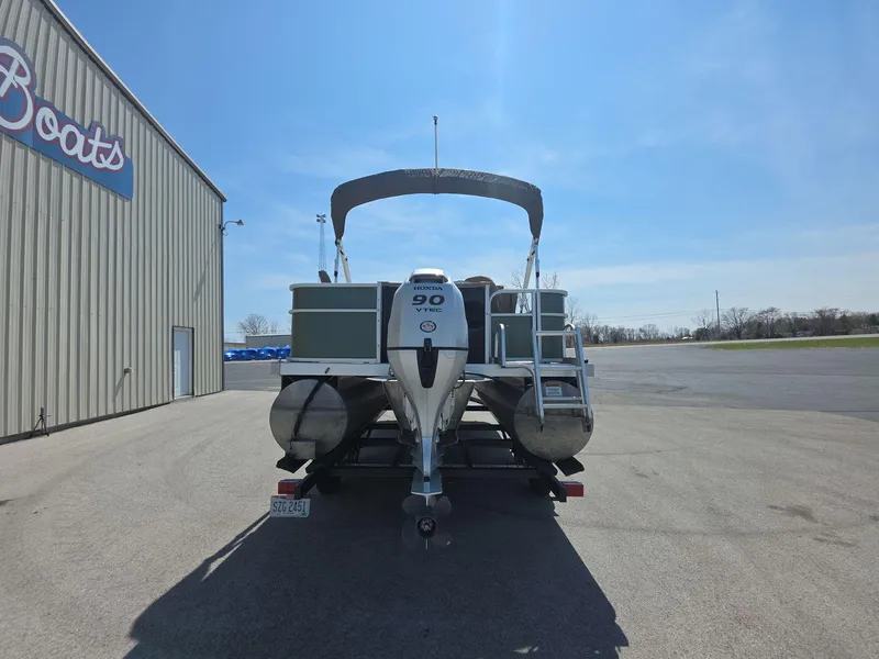 Slide: The Image of 2020 Bennington S 20 SS pontoon boat with 90 HP engine, parked outside a boat dealership. - 4