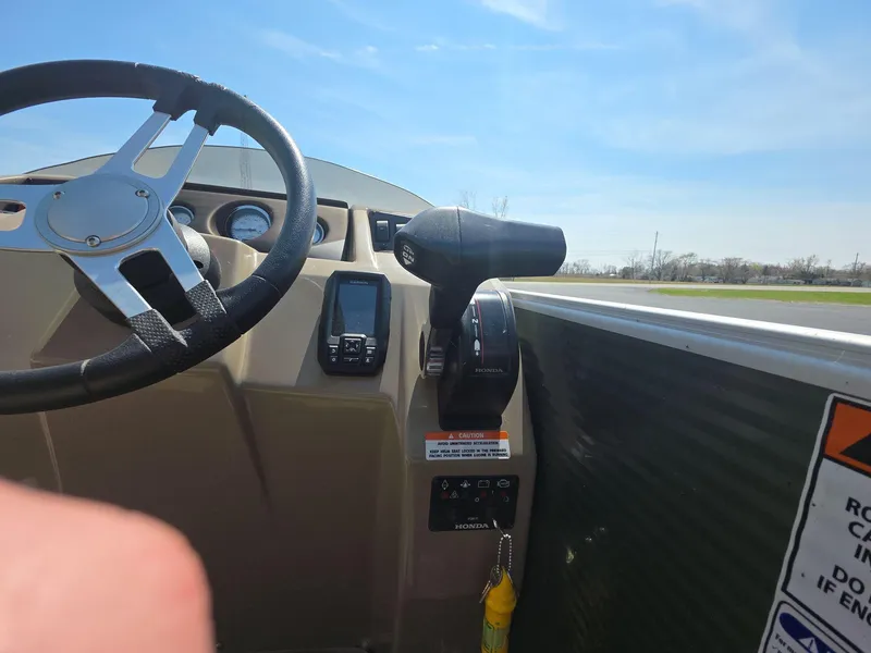 Slide: The Image of 2020 Bennington S 20 SS boat dashboard with steering wheel and controls under clear sky. - 6