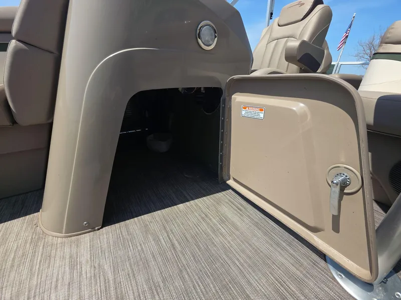 Slide: The Image of 2020 Bennington S 20 SS boat interior with open storage compartment and seating. - 7