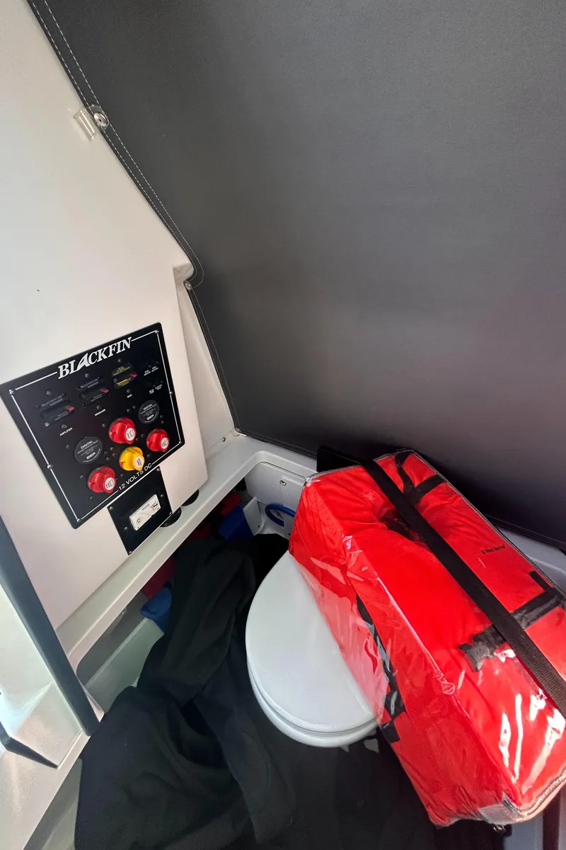 Slide: The Image of Interior of 2021 Blackfin 252 CC boat with control panel and safety equipment. - 10