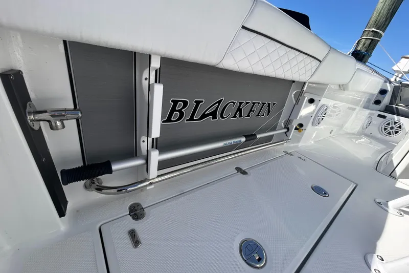 Slide: The Image of 2021 Blackfin 252 CC boat interior with branded logo and sleek design elements. - 8
