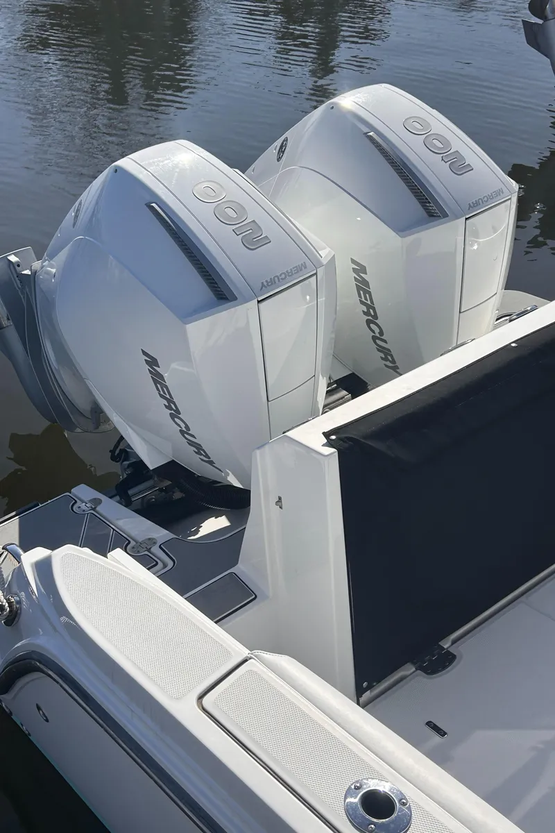 Slide: The Image of 2021 Blackfin 252 CC boat with dual Mercury outboard engines on calm water. - 9