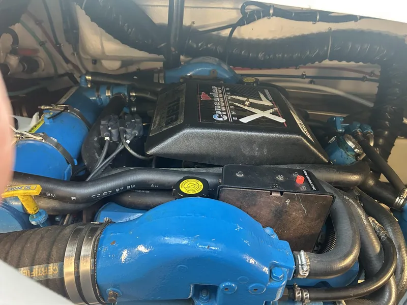 Slide: The Image of Engine compartment of a 1998 Pursuit 3400 Express boat, featuring a Crusader engine. - 13