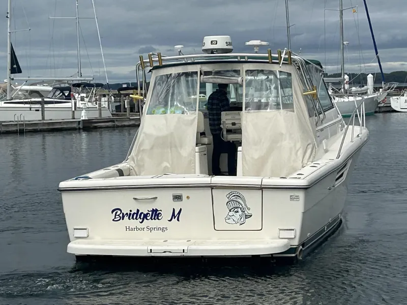 Slide: The Image of 1998 Pursuit 3400 Express boat named "Bridgette M" in a marina setting. - 4