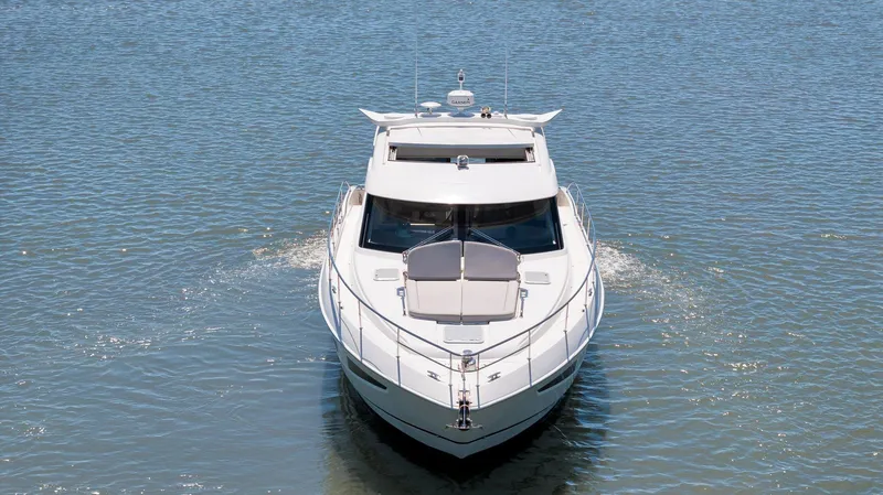 Slide: The Image of 2020 Riviera 4800 Sport Yacht cruising on calm blue waters. - 1