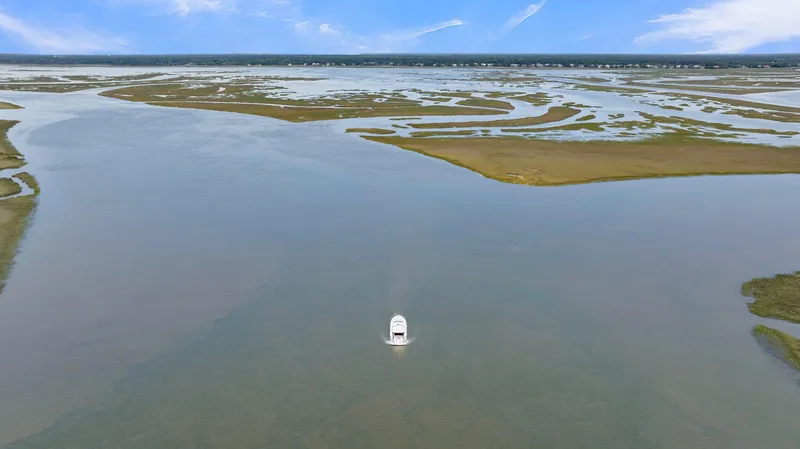 Slide: The Image of Aerial view of 2020 Riviera 4800 Sport Yacht navigating expansive coastal waters. - 14
