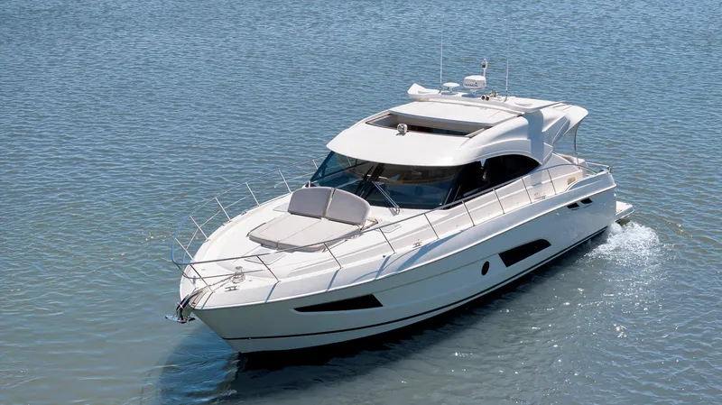 Slide: The Image of 2020 Riviera 4800 Sport Yacht cruising on calm blue waters. - 2