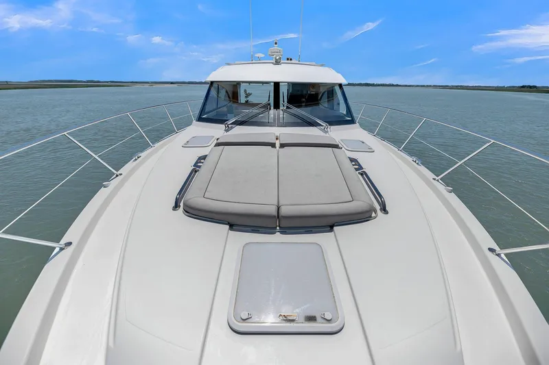 Slide: The Image of 2020 Riviera 4800 Sport Yacht on calm waters under a clear blue sky. - 21